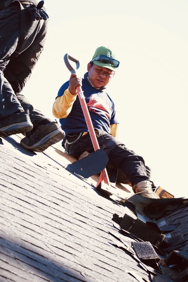 Roof tear-off and replacement in progress