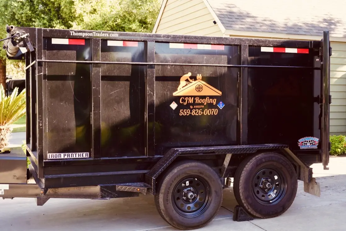 CJM Roofing branded equipment on a Central Valley job site